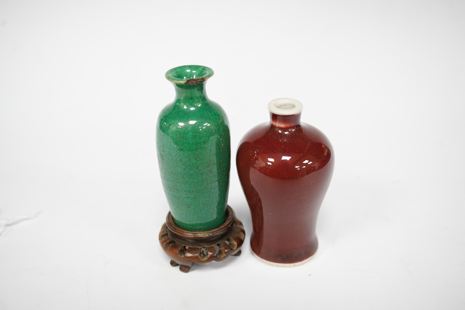 A Chinese miniature green glazed vase and a sang de boeuf snuff bottle, both 18th/19th century, largest 9cm high overall. Condition - green glazed example with chip to top rim